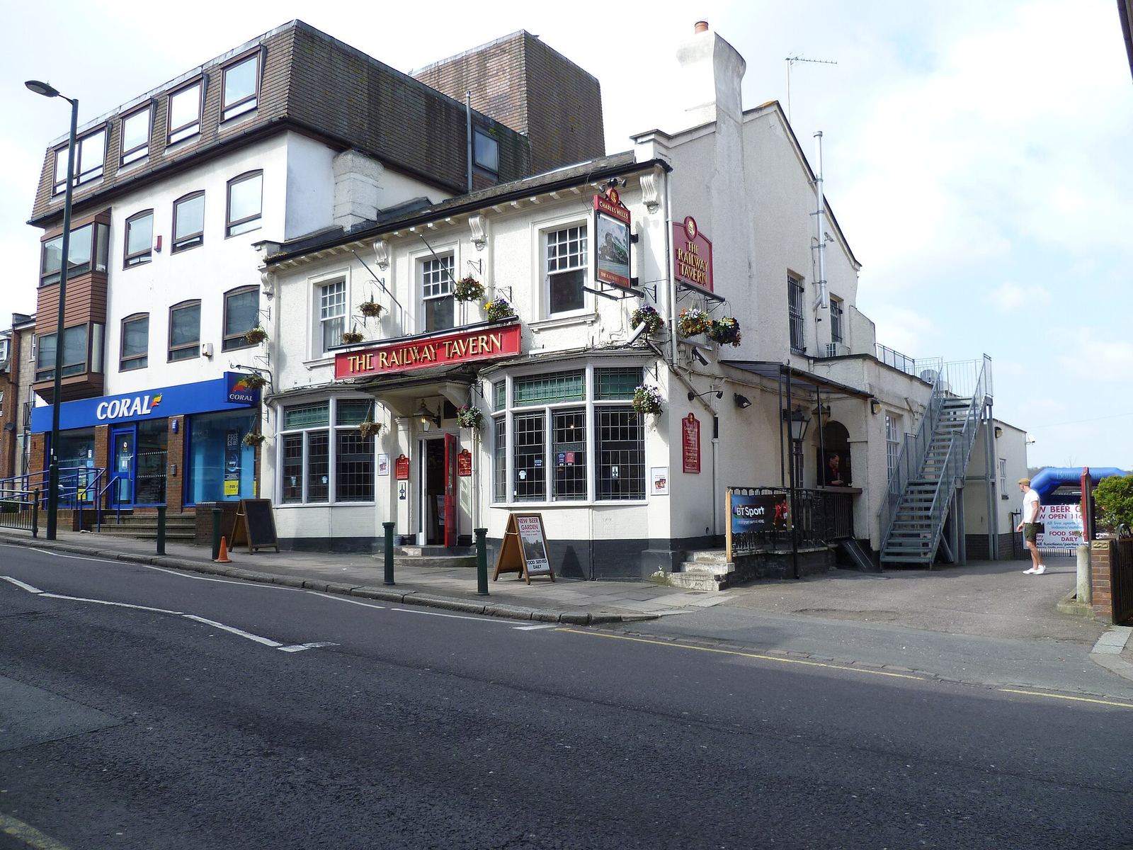 A bookmaker’s shop on the corner of a street next to a pub
