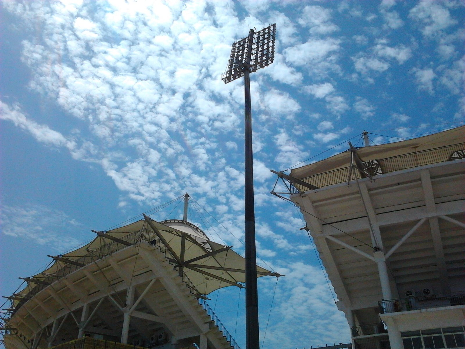 Stadium floodlight pylon against a cloudy sky
