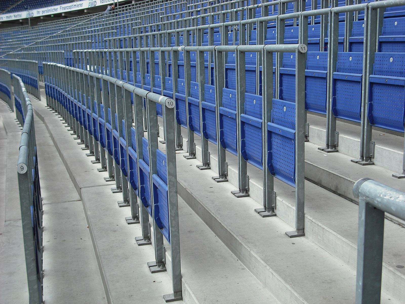 Rows of blue rail seats with waist-high barriers
