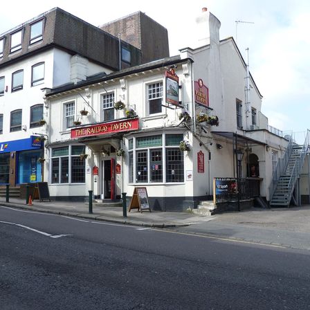 A bookmaker’s shop on the corner of a street next to a pub