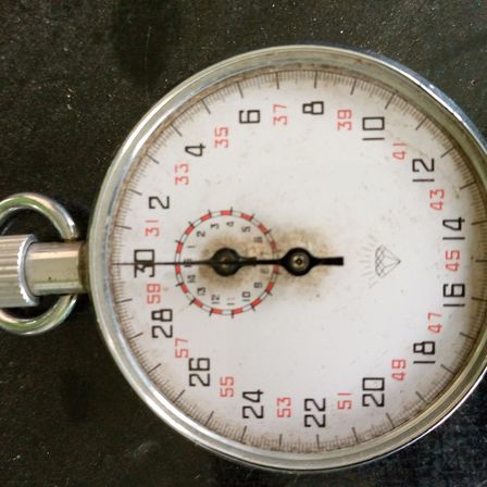 An analogue stopwatch with a white dial