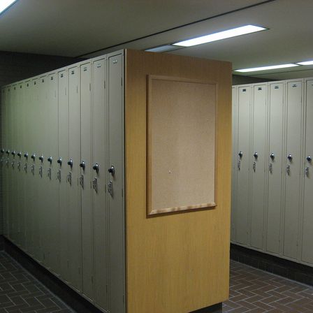 A row of metal lockers in a basement corridor