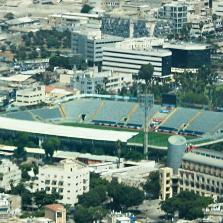 An aerial view of a stadium and the city blocks around it